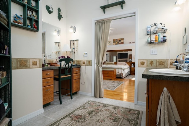 bathroom featuring tile patterned flooring, vanity, and ensuite bathroom