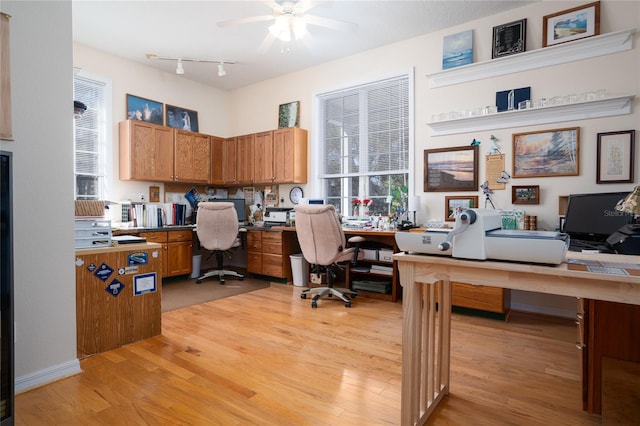 office space featuring ceiling fan, light wood-type flooring, and track lighting