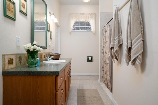 full bathroom featuring a shower with curtain, tile patterned flooring, vanity, and baseboards