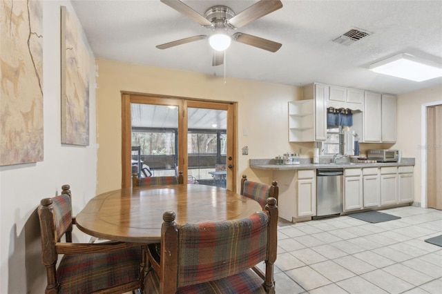 dining space with ceiling fan, visible vents, and light tile patterned flooring