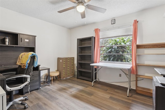 office space with ceiling fan, a textured ceiling, and wood finished floors