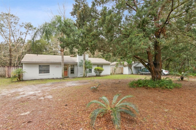 single story home featuring a chimney and fence