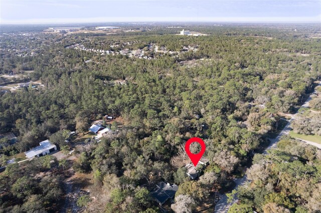 birds eye view of property with a wooded view