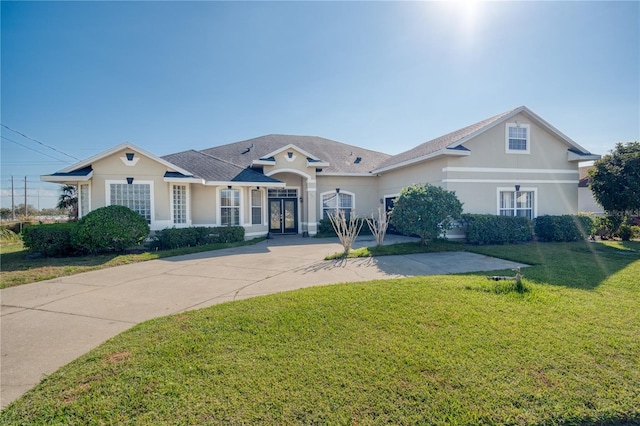 view of front of home featuring a front lawn and stucco siding