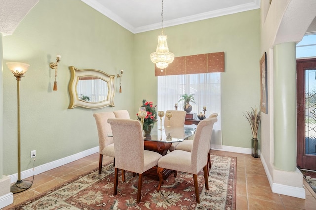 dining room with ornamental molding, baseboards, and tile patterned floors