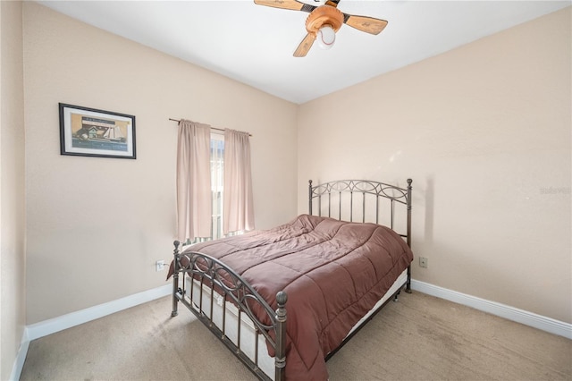 bedroom with baseboards, a ceiling fan, and light colored carpet