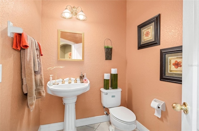 half bathroom with toilet and baseboards