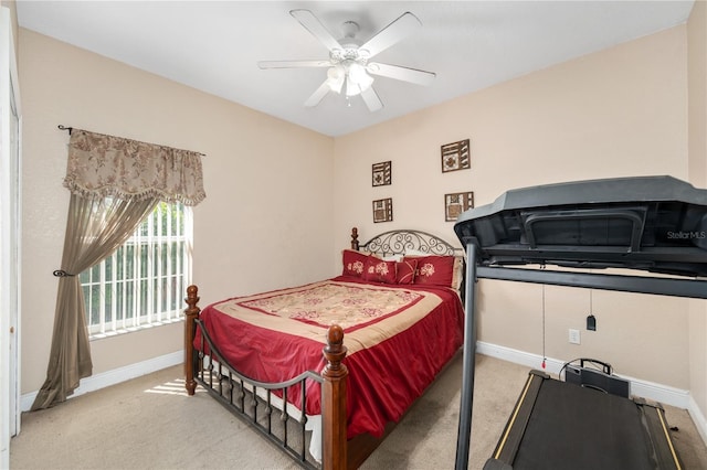 bedroom featuring baseboards, a ceiling fan, and light colored carpet