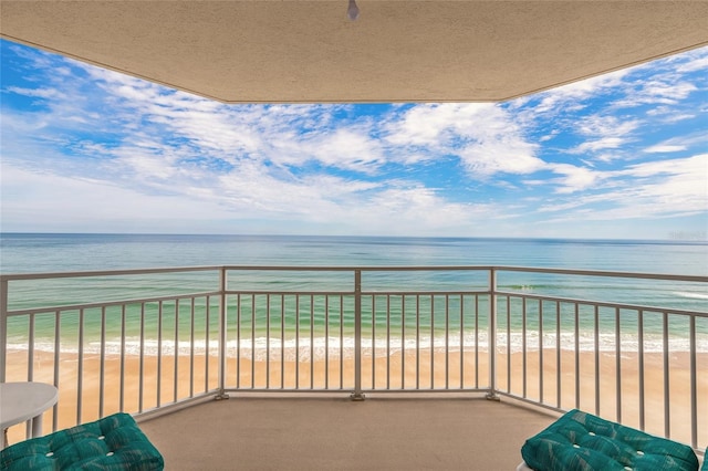 balcony with a view of the beach and a water view