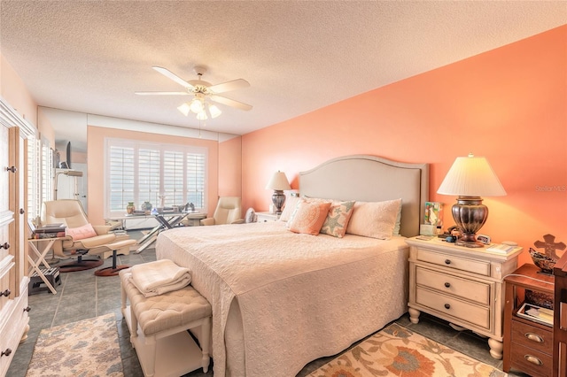 bedroom with ceiling fan and a textured ceiling