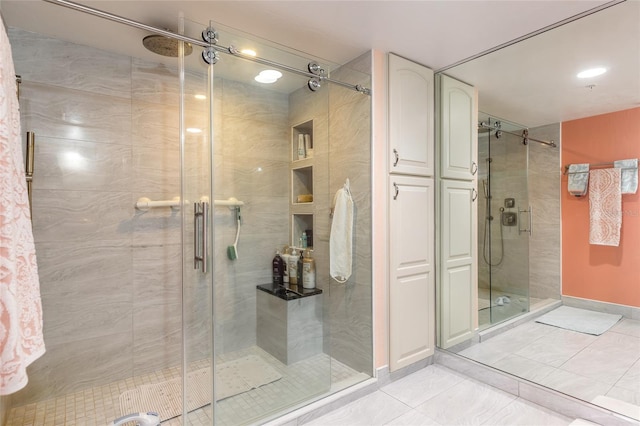 full bathroom featuring a stall shower, tile patterned flooring, and baseboards