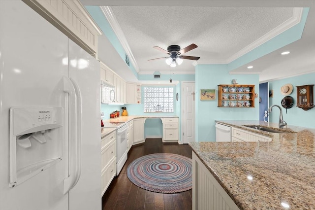 kitchen with white appliances, crown molding, dark wood finished floors, and a sink