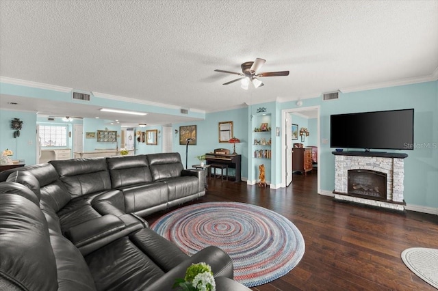 living room with a fireplace, wood finished floors, visible vents, and crown molding