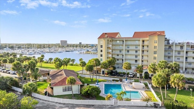 exterior space featuring a patio, a water view, and fence