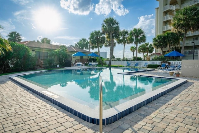 pool featuring a patio area and fence