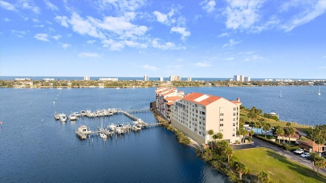 birds eye view of property featuring a water view and a city view