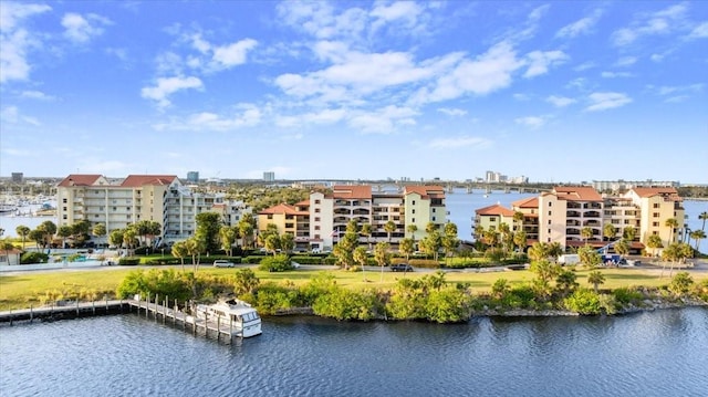 birds eye view of property featuring a water view and a city view