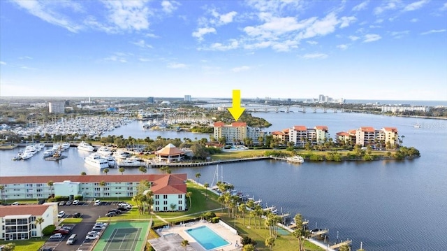 birds eye view of property with a water view and a city view