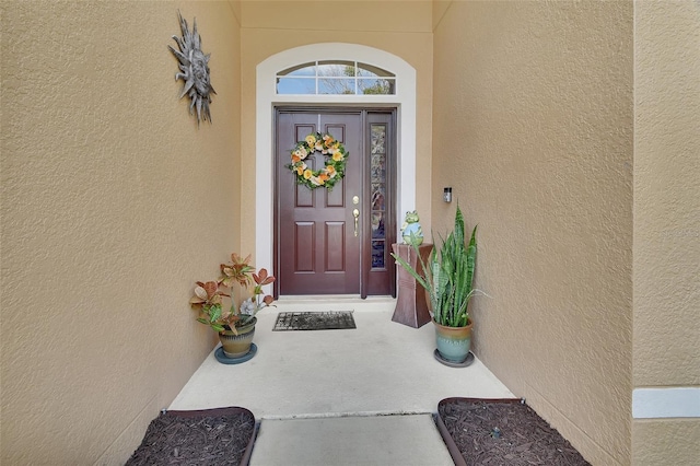 doorway to property with stucco siding