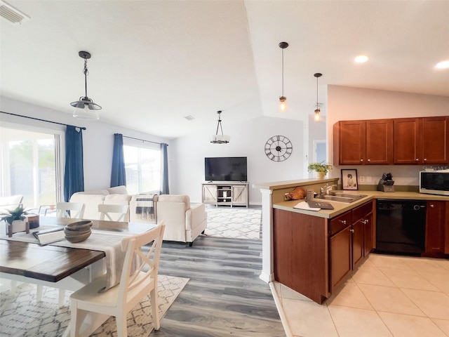 kitchen featuring dishwasher, stainless steel microwave, open floor plan, decorative light fixtures, and light countertops