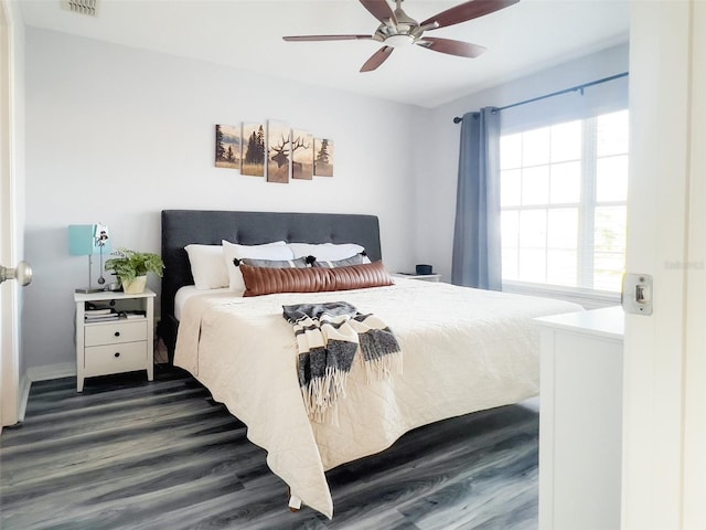 bedroom with dark wood-style floors, visible vents, and a ceiling fan