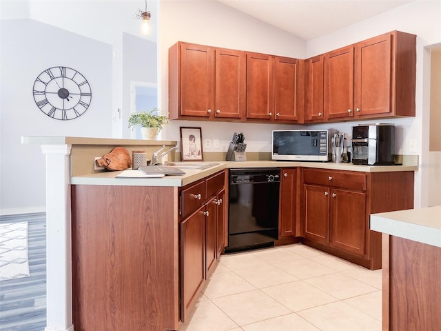 kitchen featuring vaulted ceiling, stainless steel microwave, light countertops, and dishwasher