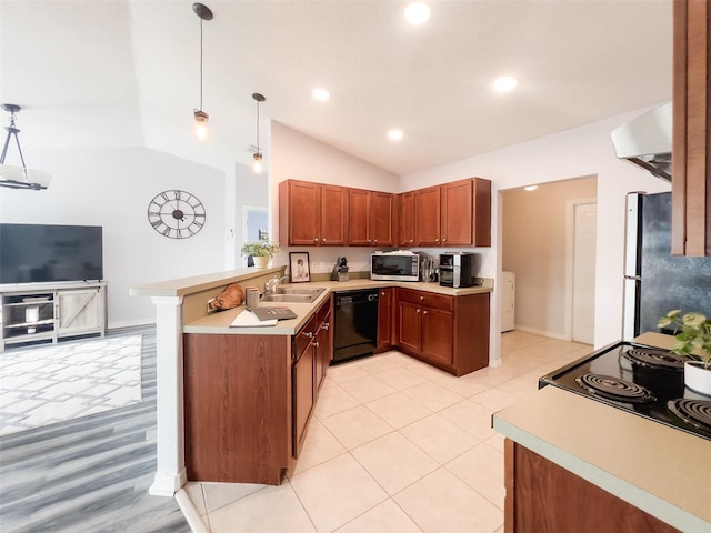 kitchen with stainless steel appliances, light countertops, a peninsula, and decorative light fixtures