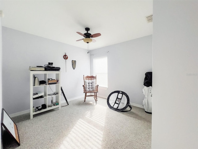 sitting room with a ceiling fan, visible vents, and baseboards