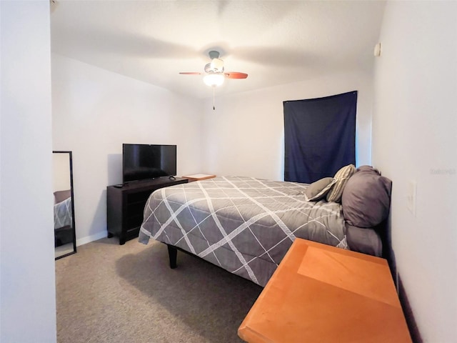 carpeted bedroom with a ceiling fan and baseboards