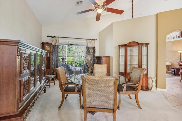 tiled dining room with visible vents, high vaulted ceiling, and ceiling fan