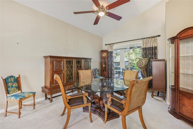 dining space featuring baseboards, carpet, a ceiling fan, and vaulted ceiling