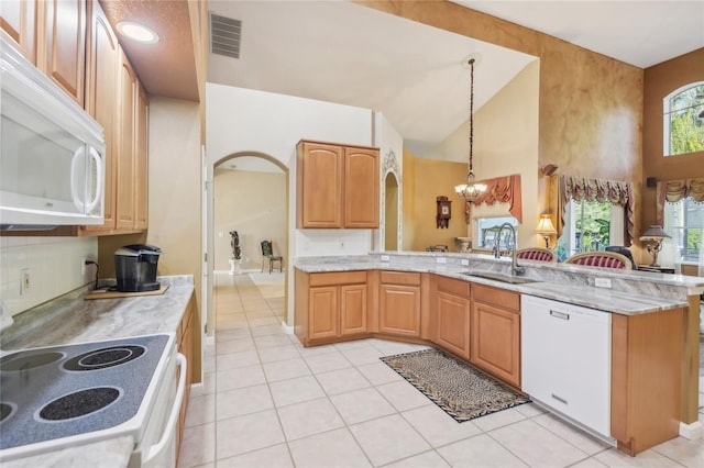 kitchen with white appliances, light stone countertops, visible vents, a sink, and a chandelier