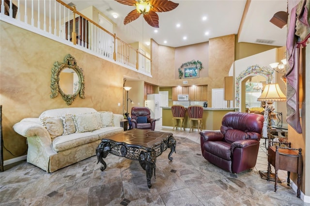 living room with recessed lighting, visible vents, a high ceiling, and a ceiling fan