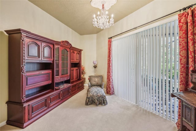 living area featuring a textured ceiling, an inviting chandelier, and carpet flooring