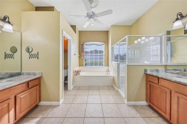 bathroom featuring tile patterned floors, a ceiling fan, two vanities, and a shower stall