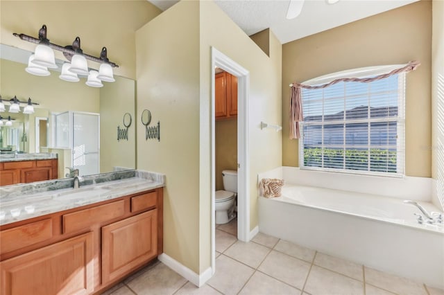 bathroom with vanity, toilet, a stall shower, tile patterned floors, and a bath