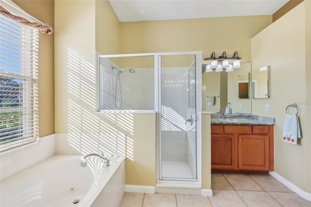 full bathroom featuring tile patterned floors, a stall shower, a tub with jets, baseboards, and vanity