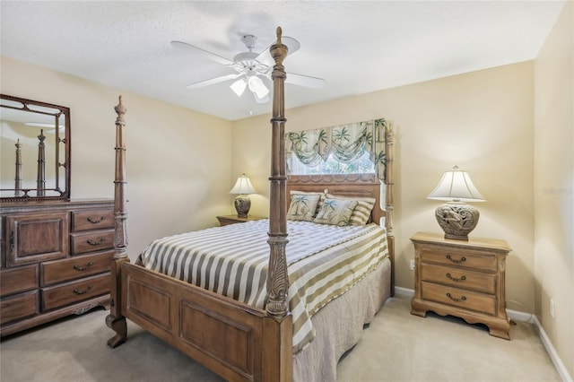 bedroom featuring baseboards, light carpet, and ceiling fan