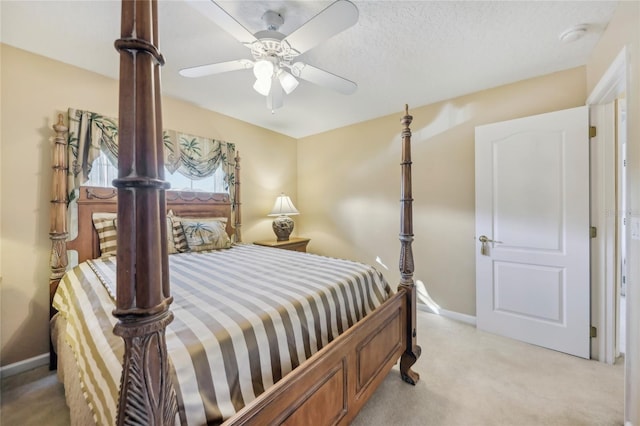 bedroom featuring baseboards, light colored carpet, and a ceiling fan