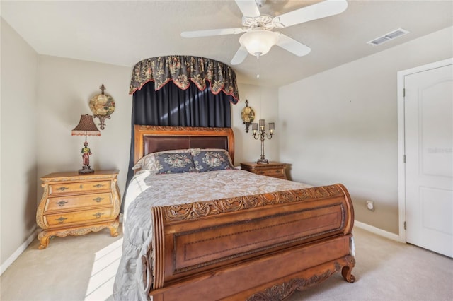 carpeted bedroom featuring visible vents, a ceiling fan, and baseboards