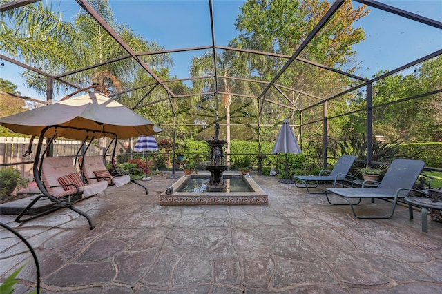 view of patio with a lanai and fence