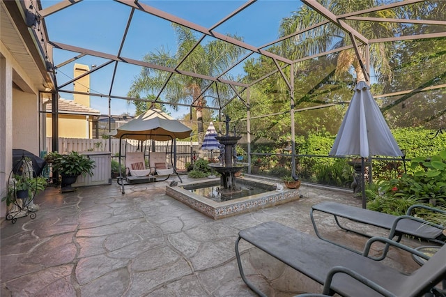 view of patio featuring glass enclosure