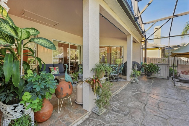 view of patio / terrace featuring glass enclosure