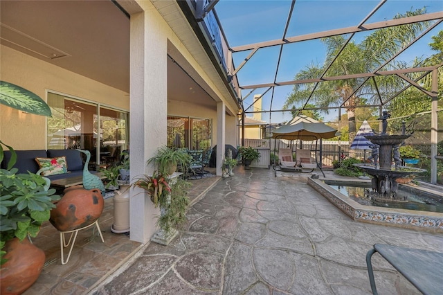 view of patio featuring glass enclosure