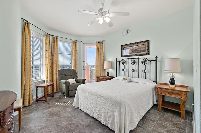 bedroom featuring baseboards, ceiling fan, and access to exterior