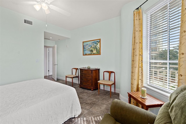 bedroom featuring visible vents, baseboards, and multiple windows