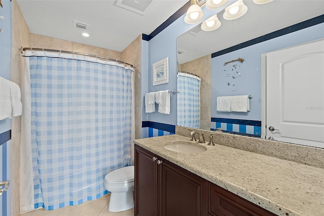 bathroom featuring tile patterned flooring, visible vents, vanity, and toilet