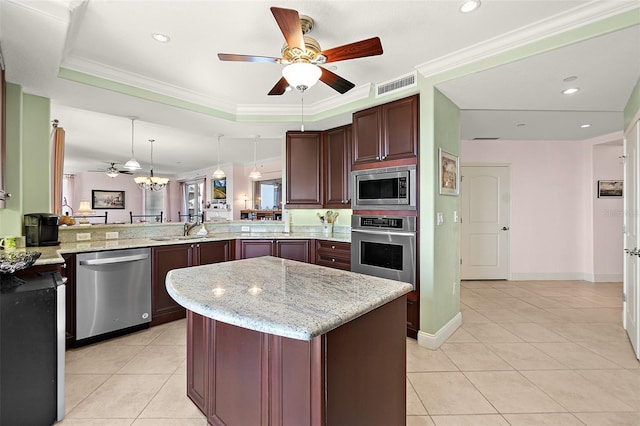 kitchen featuring light tile patterned floors, stainless steel appliances, visible vents, hanging light fixtures, and a peninsula