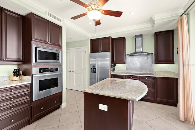 kitchen featuring visible vents, wall chimney exhaust hood, a center island, stainless steel appliances, and light tile patterned flooring