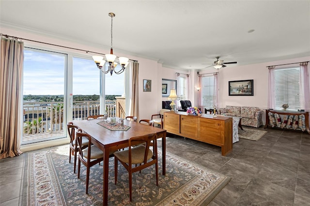 dining area with ceiling fan with notable chandelier and ornamental molding